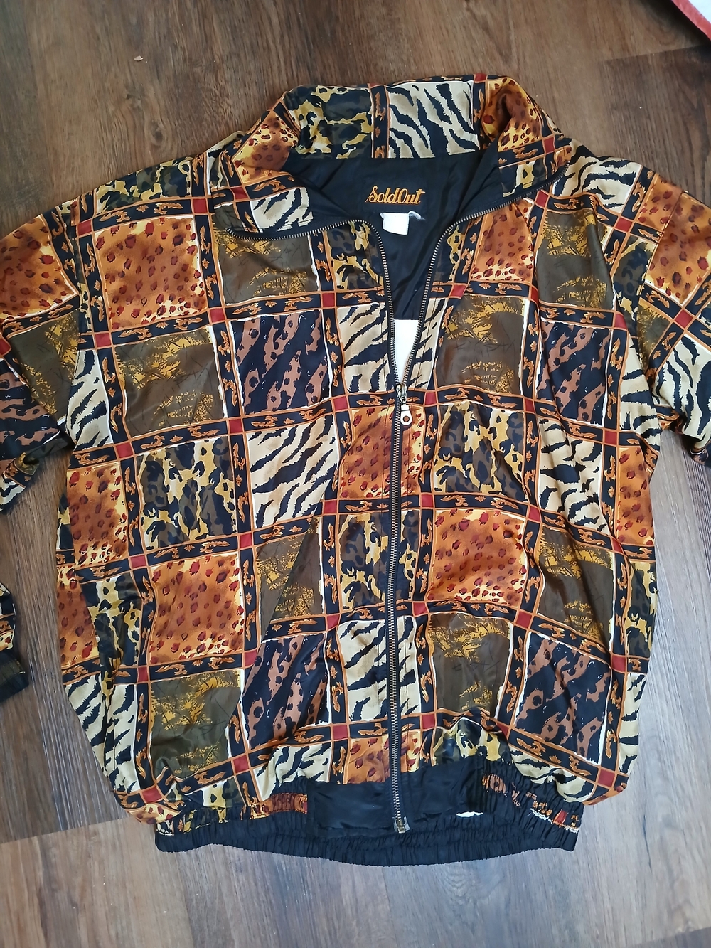 vintage SoldOut brand windbreaker jacket featuring a patchwork animal print